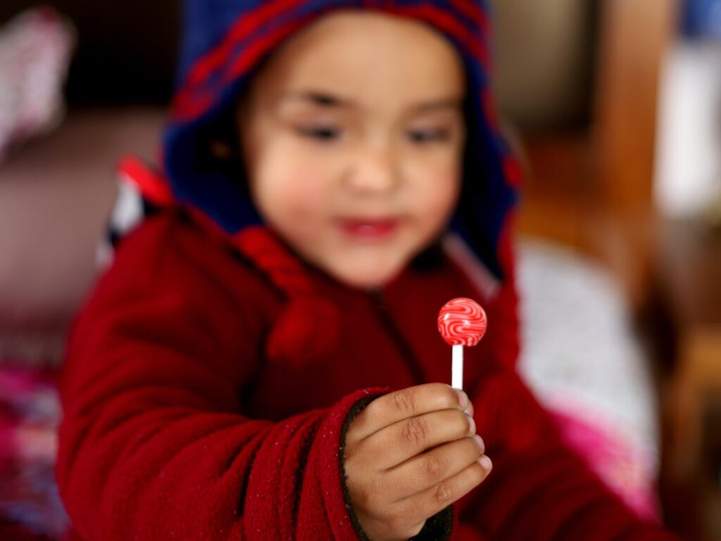 child holding a lollypop